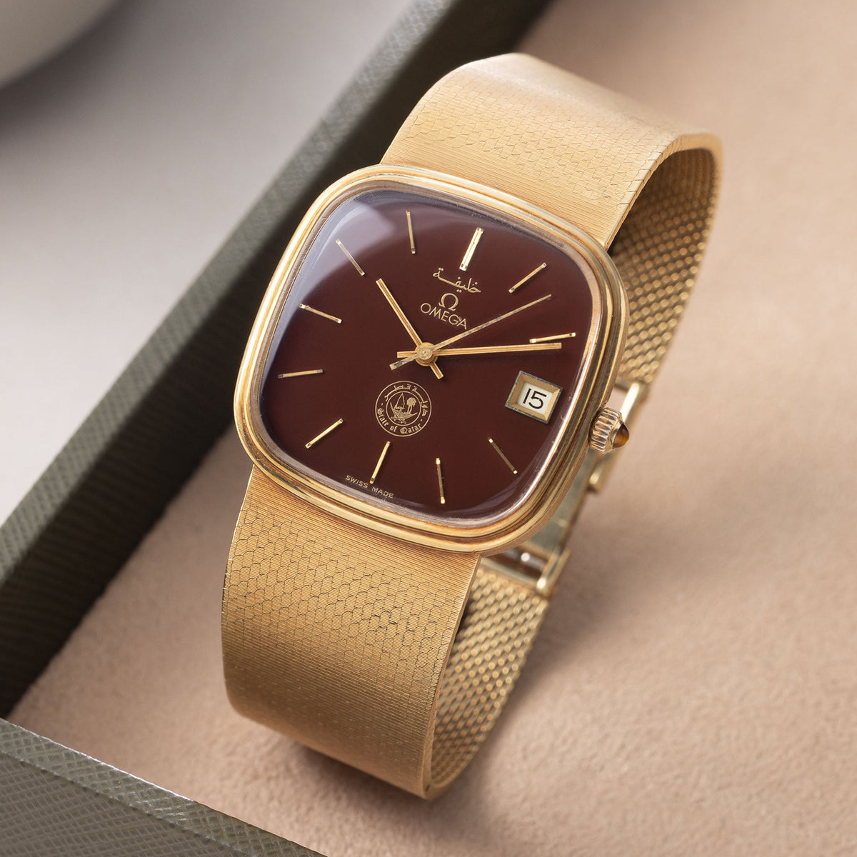Omega "State of Qatar" Squared Dresswatch Oxblood Stella-esque Dial from Original Owner Family in 18k yellow Gold with integrated Woven Bracelet 

